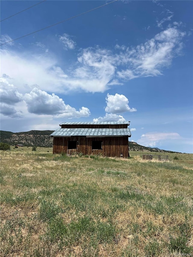 view of pole building with a rural view