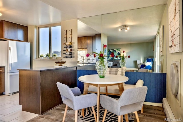dining area with light wood-style flooring
