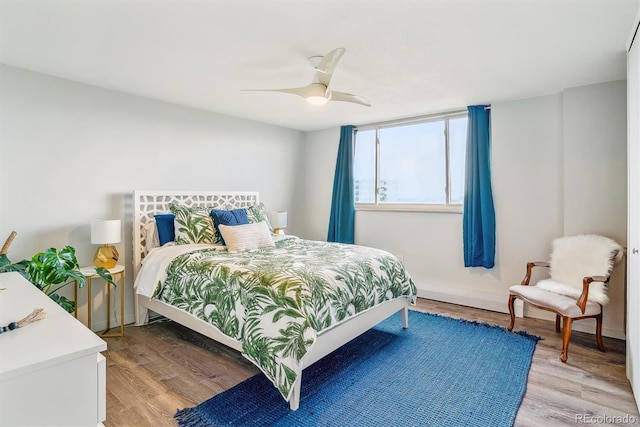 bedroom with ceiling fan and light wood-type flooring
