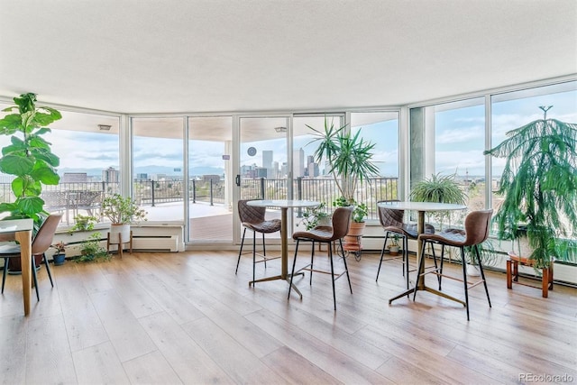 sunroom featuring a city view and a wealth of natural light