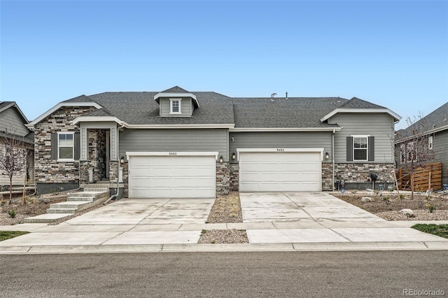 view of front facade with stone siding, concrete driveway, and an attached garage