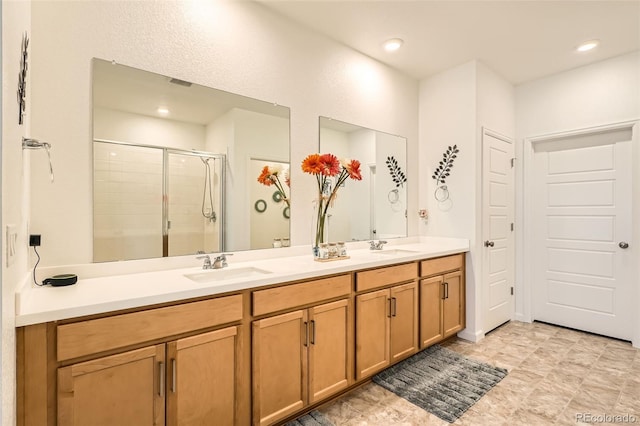 bathroom with a stall shower, double vanity, and recessed lighting