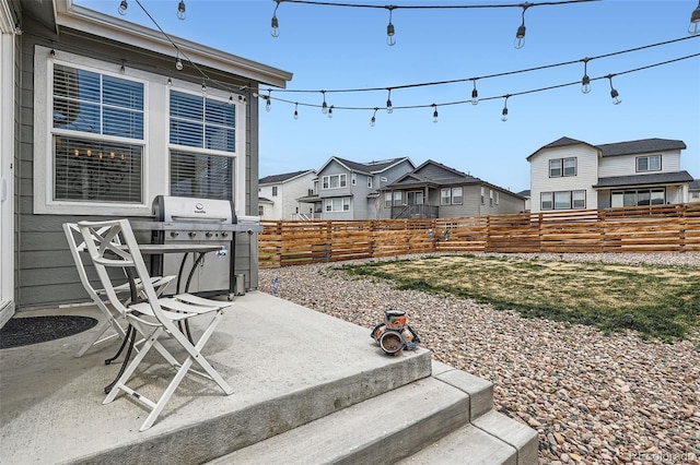 view of yard featuring fence, a residential view, and a patio