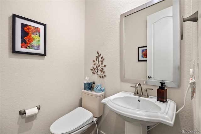 bathroom with toilet and sink