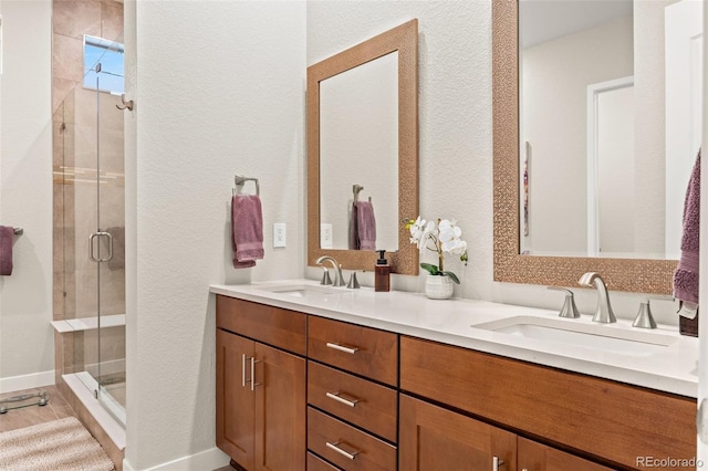 bathroom featuring vanity and an enclosed shower