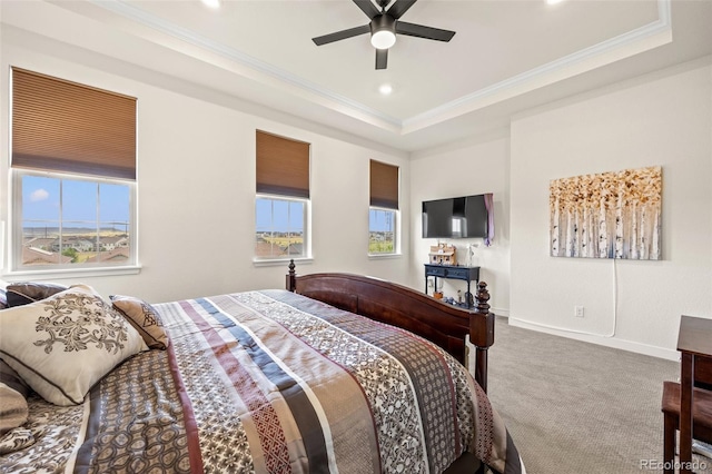 bedroom featuring a raised ceiling, ornamental molding, carpet flooring, and multiple windows