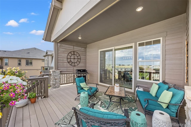 wooden terrace with a grill