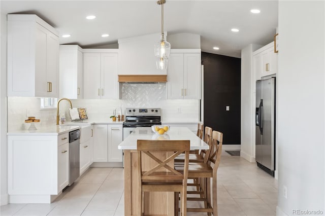 kitchen featuring a sink, stainless steel appliances, light countertops, and recessed lighting