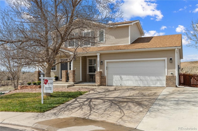 traditional-style home featuring concrete driveway, brick siding, fence, and a porch