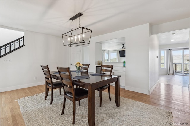 dining space with baseboards, light wood-style floors, and a healthy amount of sunlight