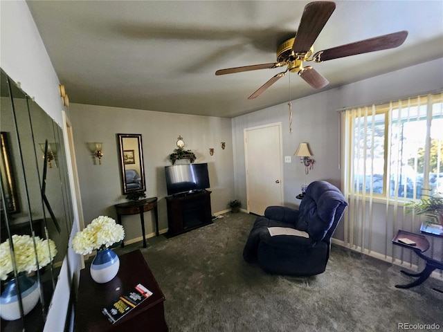 living area featuring baseboards and dark colored carpet