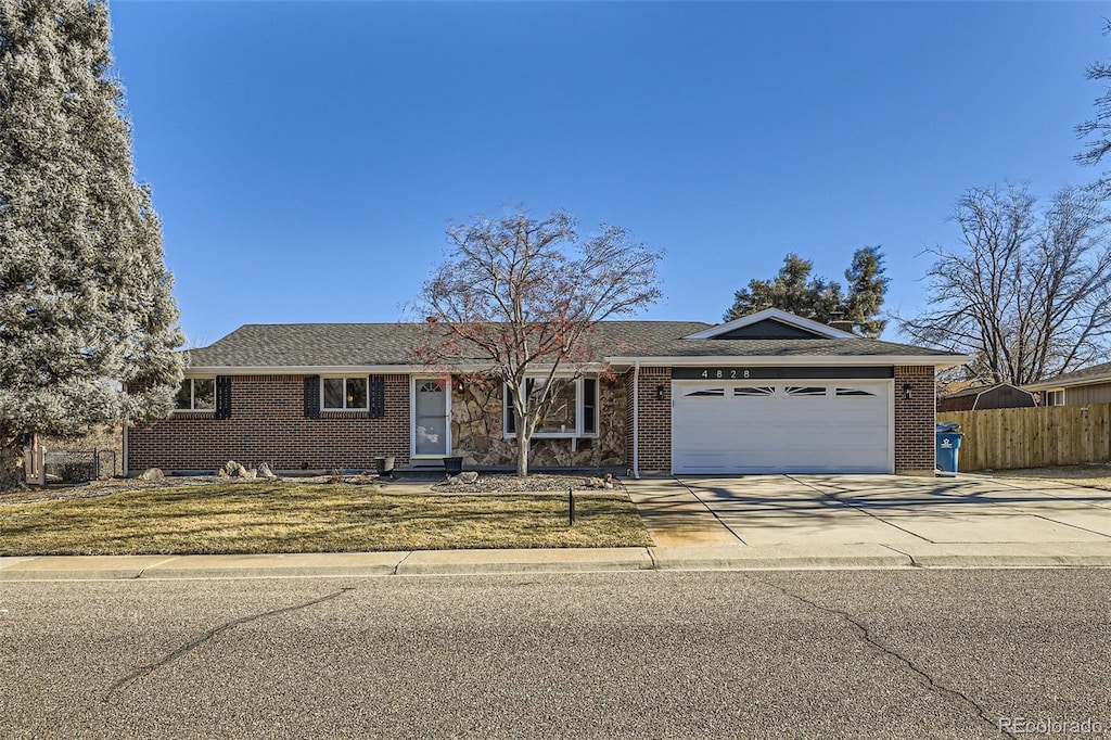 ranch-style house with a front yard and a garage