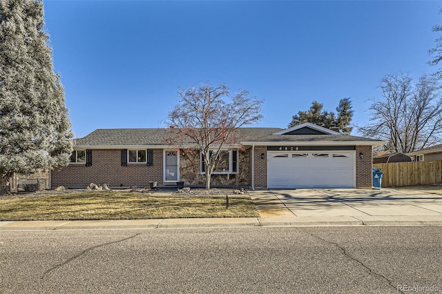 ranch-style house with a front yard and a garage