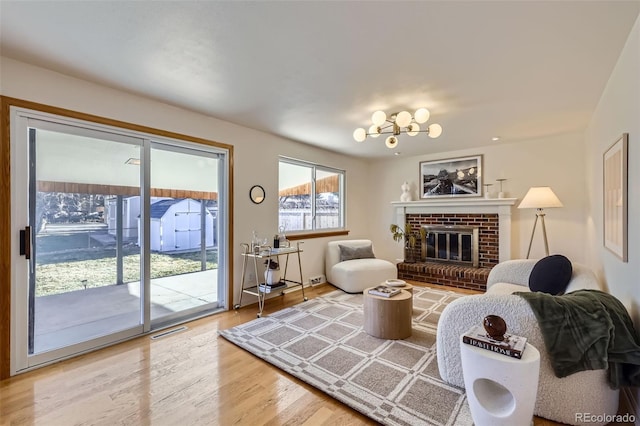 living room with hardwood / wood-style floors and a brick fireplace