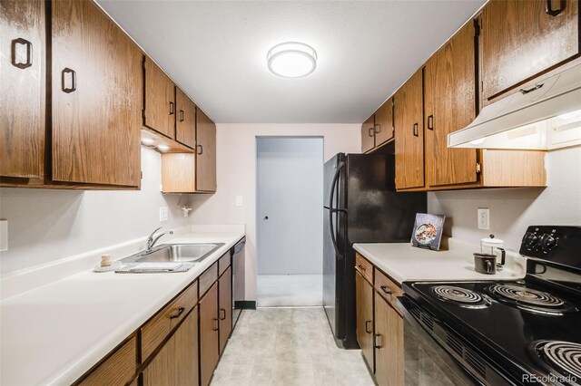 7770 W 38th Ave Unit 207, Wheat Ridge, CO 80033 - kitchen with black electric range oven, under cabinet range hood, a sink, and light countertops