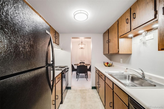 7770 W 38th Ave Unit 207, Wheat Ridge, CO 80033 - kitchen featuring black appliances, a sink, light countertops, brown cabinets, and under cabinet range hood