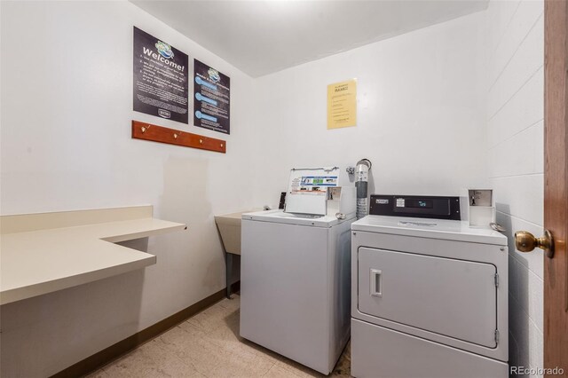 7770 W 38th Ave Unit 207, Wheat Ridge, CO 80033 - communal laundry room featuring separate washer and dryer and baseboards