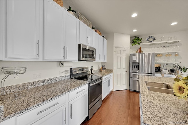 675 W 171st Pl, Broomfield, CO 80023 - kitchen featuring stainless steel appliances, recessed lighting, white cabinets, light stone countertops, and dark wood-style floors