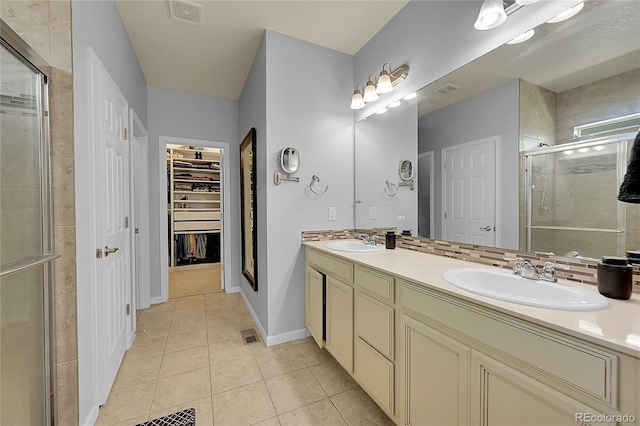 675 W 171st Pl, Broomfield, CO 80023 - full bath with double vanity, a shower stall, tile patterned flooring, and a walk in closet