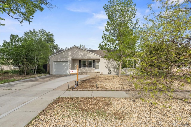 2415 N Logan Ave, Colorado Springs, CO 80907 - ranch-style home featuring a garage, concrete driveway, and stucco siding