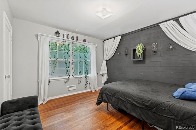 2415 N Logan Ave, Colorado Springs, CO 80907 - bedroom with light wood finished floors, baseboards, and an accent wall