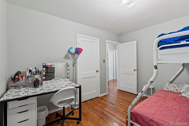 2415 N Logan Ave, Colorado Springs, CO 80907 - bedroom featuring wood finished floors, an office area, and baseboards