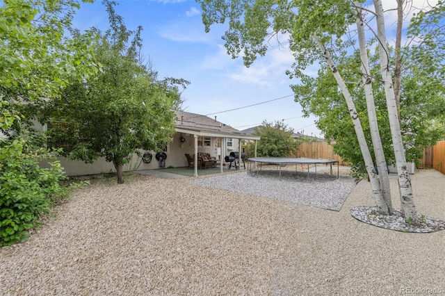 2415 N Logan Ave, Colorado Springs, CO 80907 - fenced backyard with a trampoline and a patio area