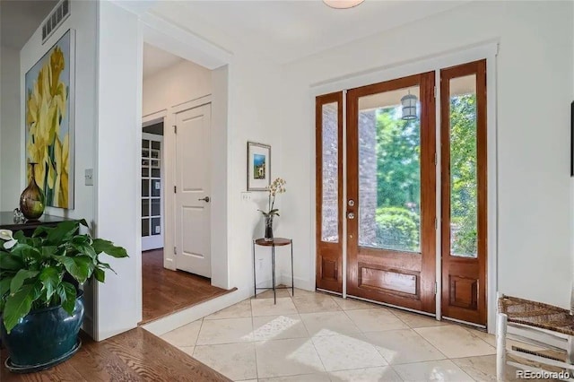 doorway to outside with light tile patterned floors