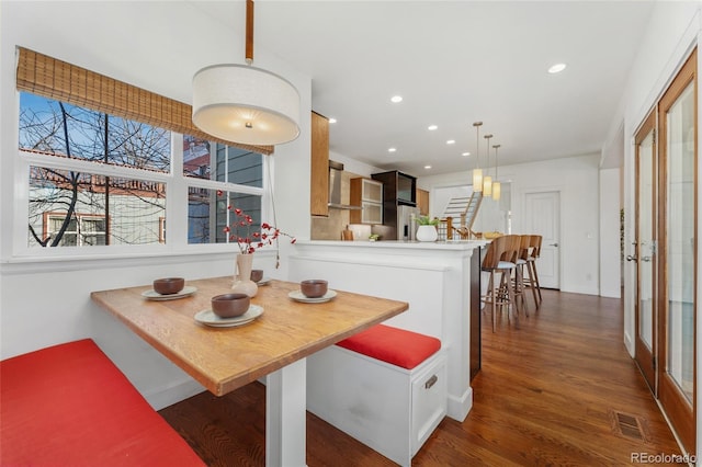 dining area featuring dark wood-type flooring