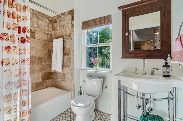 bathroom with shower / bath combo and toilet