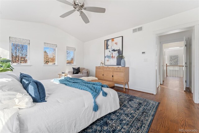 bedroom with ceiling fan, wood-type flooring, and vaulted ceiling