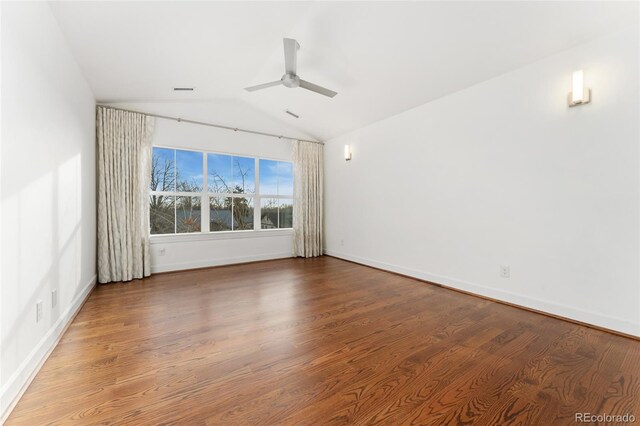 empty room with lofted ceiling, hardwood / wood-style floors, and ceiling fan