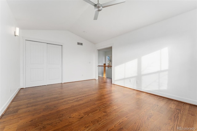 interior space with ceiling fan, dark hardwood / wood-style flooring, vaulted ceiling, and a closet