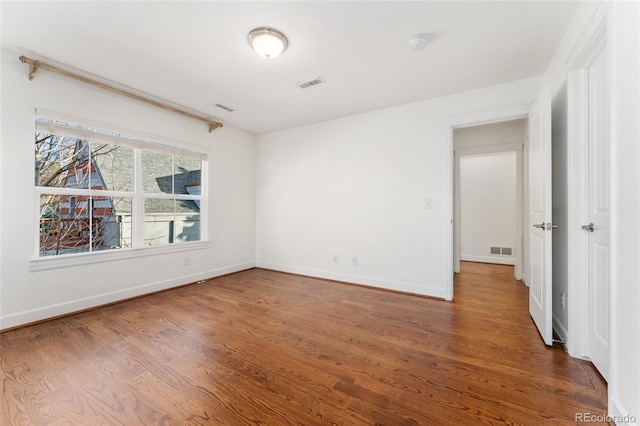 unfurnished room featuring hardwood / wood-style flooring