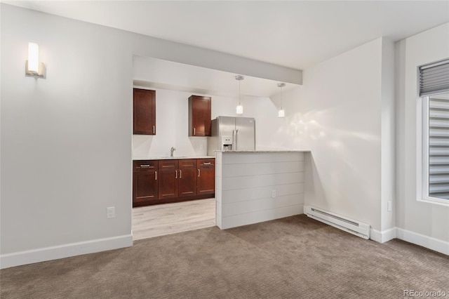 kitchen featuring sink, hanging light fixtures, light colored carpet, baseboard heating, and stainless steel refrigerator with ice dispenser