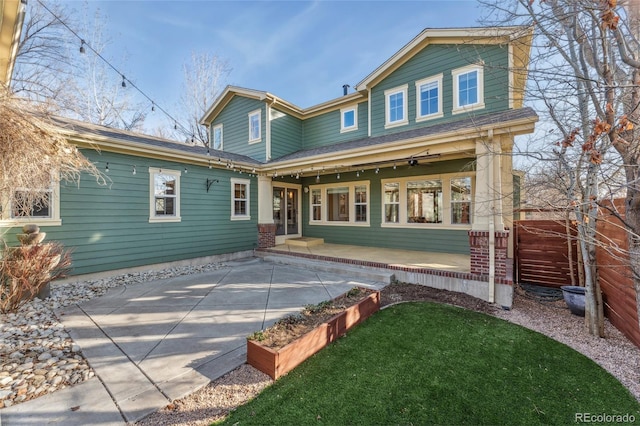 rear view of property with a patio area and a lawn