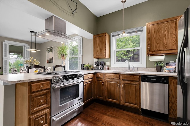 503 15th St, Golden, CO 80401 - kitchen featuring appliances with stainless steel finishes, wall chimney exhaust hood, a peninsula, light countertops, and a sink
