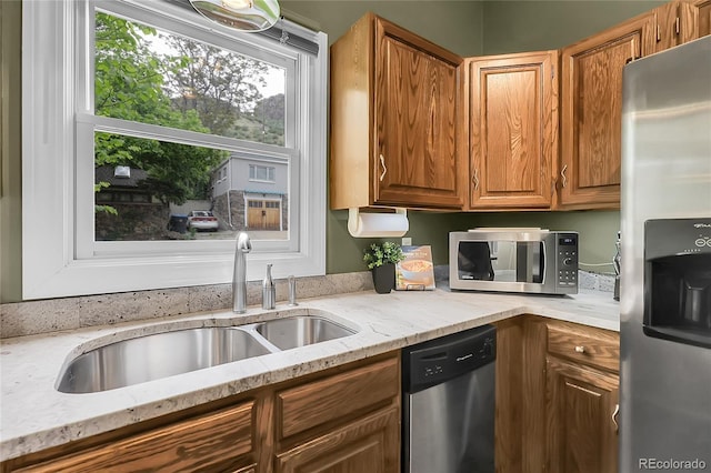 503 15th St, Golden, CO 80401 - kitchen with stainless steel appliances, a sink, light stone countertops, and brown cabinetry