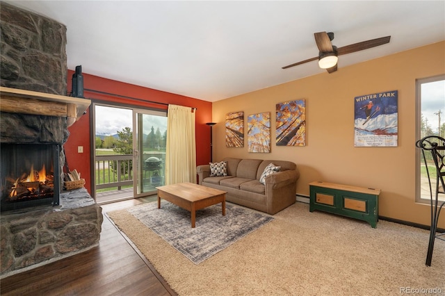 397 County Road 834 Unit 8, Fraser, CO 80442 - living room with a ceiling fan, a fireplace, a baseboard radiator, and baseboards
