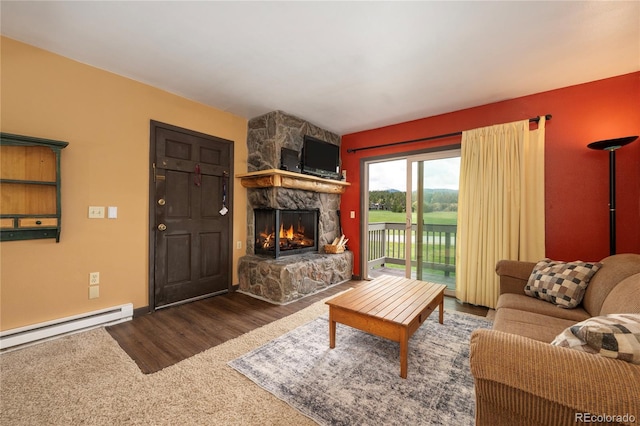 397 County Road 834 Unit 8, Fraser, CO 80442 - carpeted living area featuring a stone fireplace, baseboard heating, wood finished floors, and baseboards