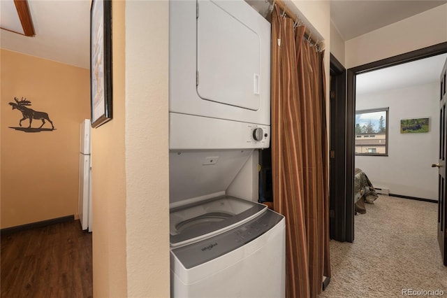 397 County Road 834 Unit 8, Fraser, CO 80442 - washroom with estacked washer and dryer, a baseboard heating unit, and baseboards