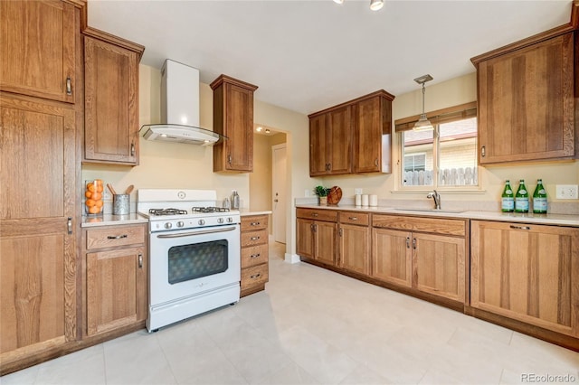 3211 Olive St, Denver, CO 80207 - kitchen featuring wall chimney exhaust hood, a sink, light countertops, and gas range gas stove