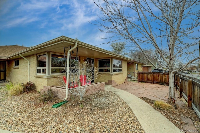 3211 Olive St, Denver, CO 80207 - view of front of property with brick siding and fence