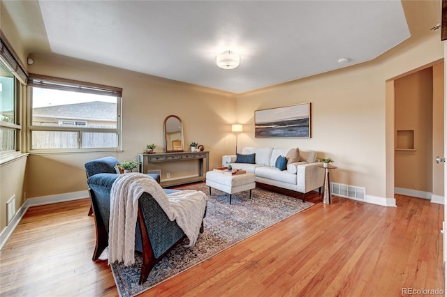 3211 Olive St, Denver, CO 80207 - living area with visible vents, light wood finished floors, and baseboards