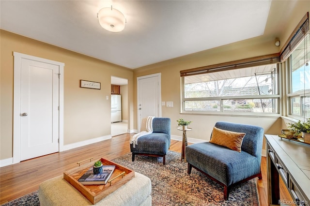 3211 Olive St, Denver, CO 80207 - sitting room with wood finished floors and baseboards