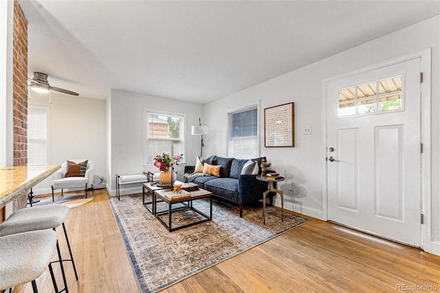 living room featuring hardwood / wood-style flooring and ceiling fan