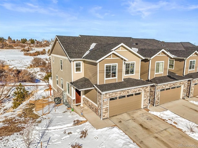 view of front of property with central AC unit and a garage