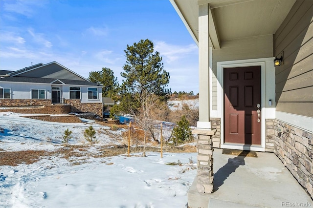 view of snow covered property entrance