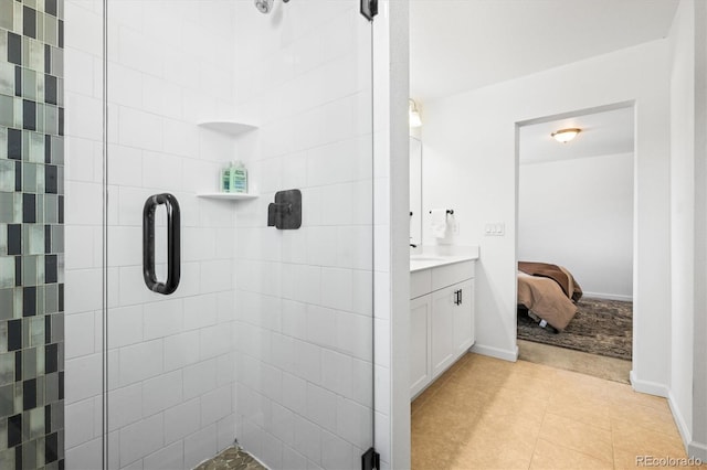 bathroom with tile patterned flooring, a shower with door, and vanity