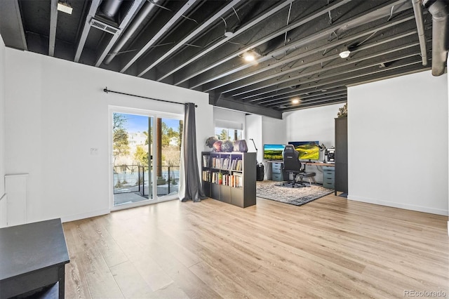 basement with light hardwood / wood-style flooring